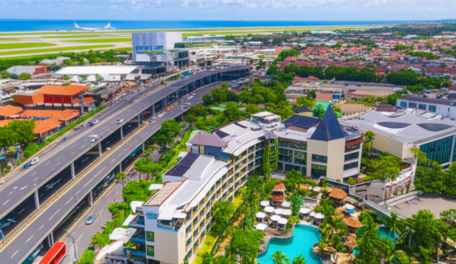 Aerial view of Bali showing commercial buildings, hotels, and infrastructure reflecting the island's tourism and economic growth.