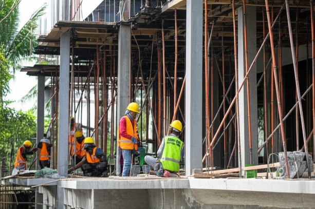 Construction workers in Bali building a commercial property, showcasing expertise and adherence to quality standards.