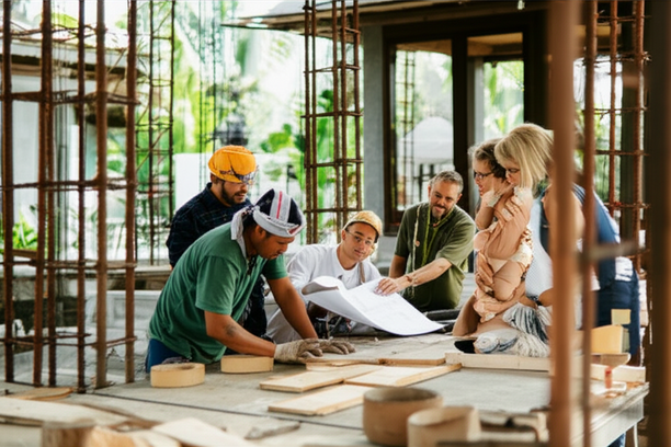 A collaborative construction project in Bali, showcasing a team of professionals and local artisans working together.