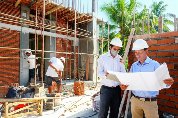 Construction site in Bali with workers building a house
