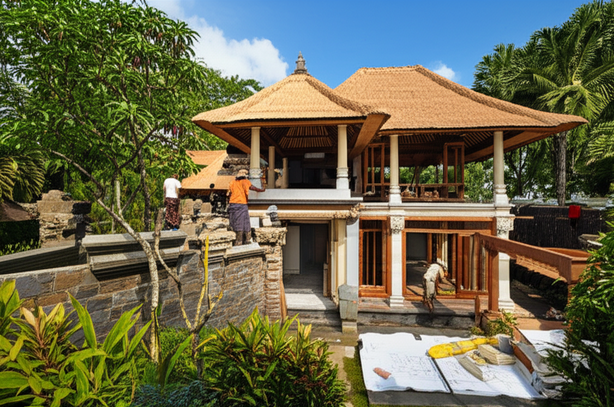 A luxury Balinese villa under construction, showcasing traditional architecture and tropical surroundings.