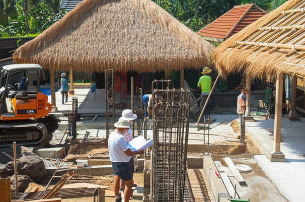 Construction site in Bali, illustrating the different stages of building a villa, from site preparation to roofing and finishing work.
