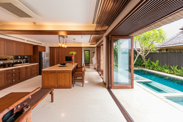 Luxurious Bali villa interior with hardwood floors, bespoke cabinetry, and a view of a private pool and tropical garden.