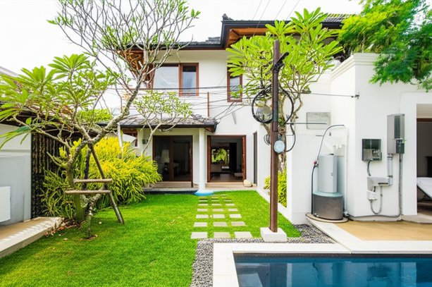 A beautiful Balinese villa with modern utilities and lush landscaping, representing a comfortable and sustainable lifestyle.