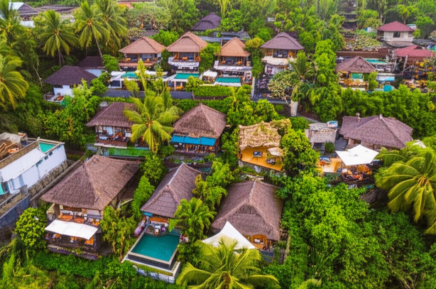 Aerial view of Bali's yellow zone showcasing sustainable tourism developments, including boutique hotels, villas, and restaurants integrated into the natural landscape.