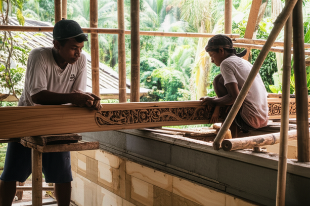 Balinese construction site showcasing natural stone, wood carving, and integration of traditional and modern building techniques.