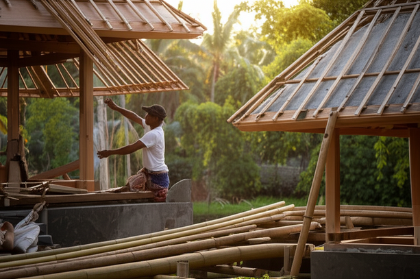 A Balinese craftsman working on a building, showcasing sustainable materials and local construction techniques.