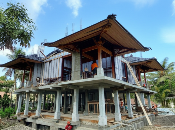 Balinese home under construction, showing reinforced concrete framing, timber integration, and climate-resistant features.