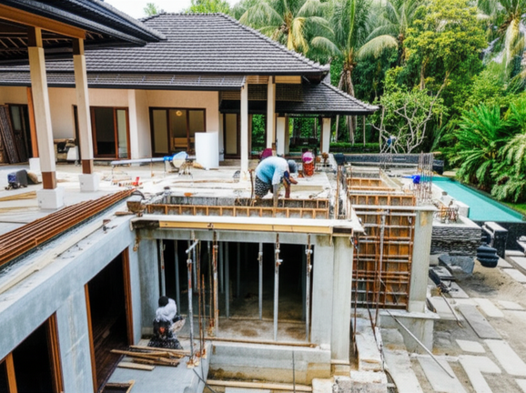 Construction of a luxury built-in home in Bali, showcasing various construction phases and high-end finishes.