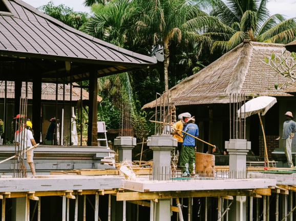 Construction of a Balinese villa, showcasing architectural details and integration with the tropical environment