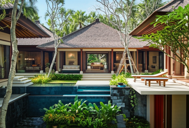 Aerial view of a Balinese villa designed with Tropical Modernism principles, showcasing open pavilions, lush gardens, and a seamless connection between indoor and outdoor spaces.