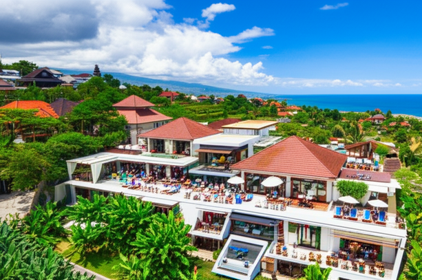 A photograph showing Bali's diverse commercial landscape, with resorts, shops, cafes, co-working spaces, and natural beauty.