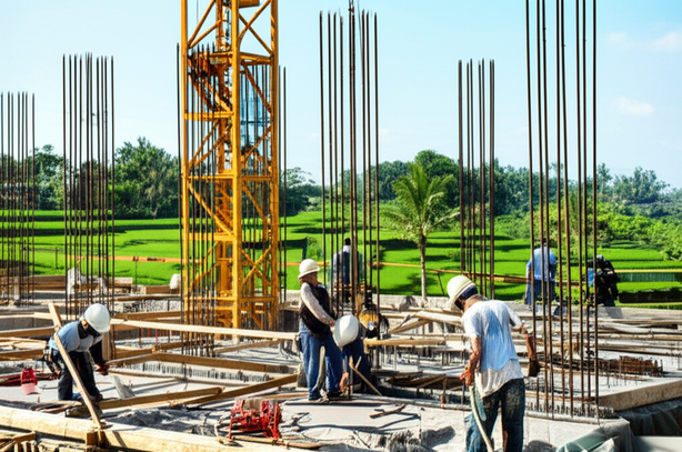 Illustration of a commercial construction project in Bali, showcasing a building under construction with local workers and Balinese scenery.