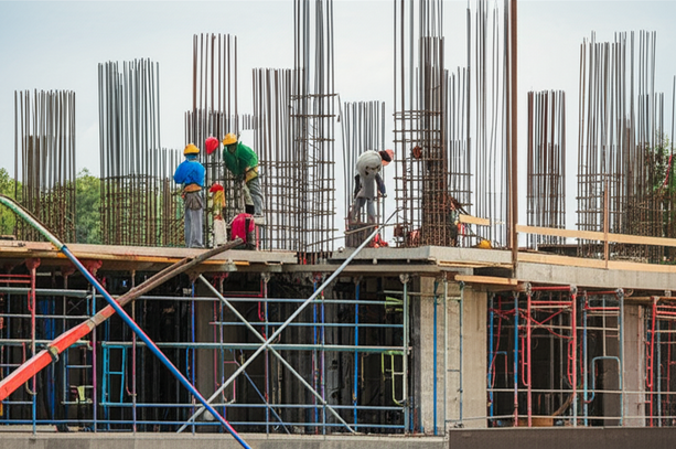 A commercial construction site in Bali, showing various aspects of building construction, highlighting the role of subcontractors.