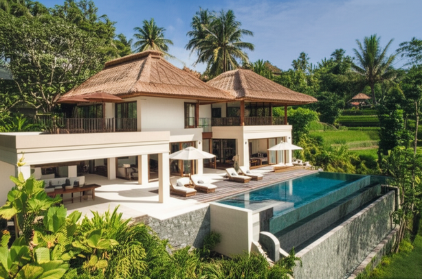 A stunning, modern villa in Bali with an infinity pool overlooking a tropical landscape, representing the dream home the article discusses.
