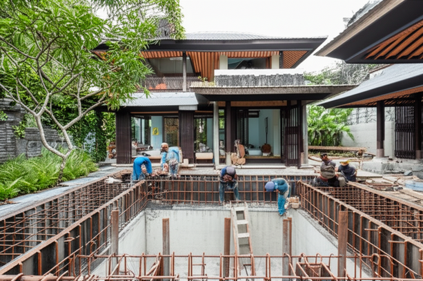 A luxury villa under construction in Bali, showcasing integrated construction and project management with a blend of modern design and traditional Balinese architecture.