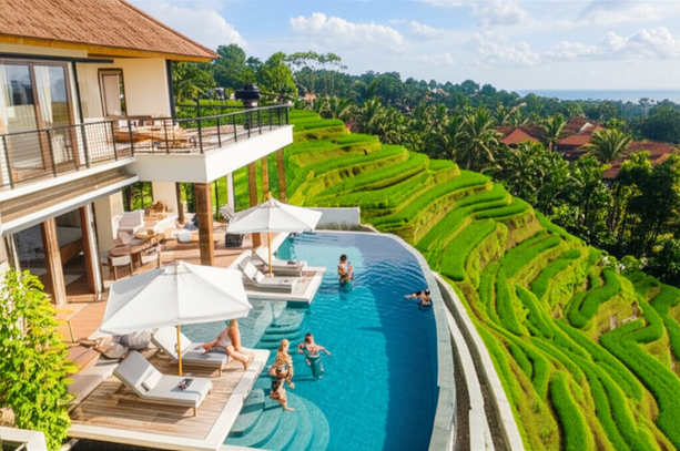 Aerial view of a luxury Bali villa with a private infinity pool overlooking rice terraces