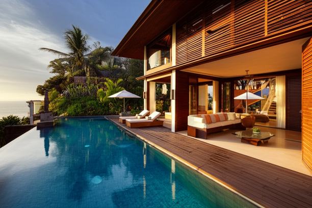 Luxurious Balinese villa with infinity pool and ocean view, representing a high-end residential investment opportunity.