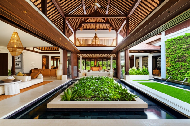 A modern Balinese villa showcasing a blend of traditional and contemporary design elements, including open living areas, courtyards, and intricate carvings.