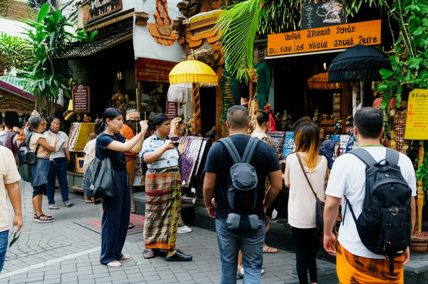 A busy street scene in Ubud, Bali, with tourists and locals engaged in various activities.