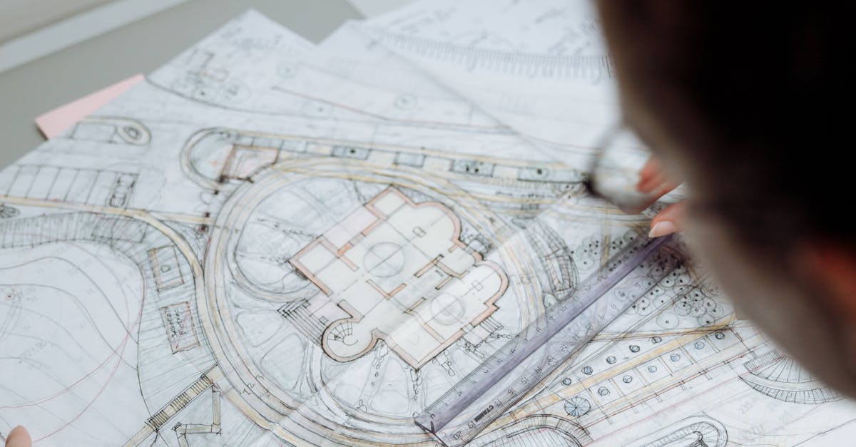 Professional architect analyzing detailed blueprints at a workplace.