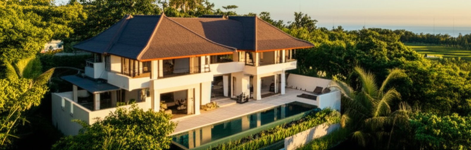 A stunning, completed modern villa in Bali, demonstrating a successful general contractor project, blending traditional design with contemporary architecture amidst lush tropical landscapes and a scenic backdrop of the ocean or rice fields, captured during golden hour.